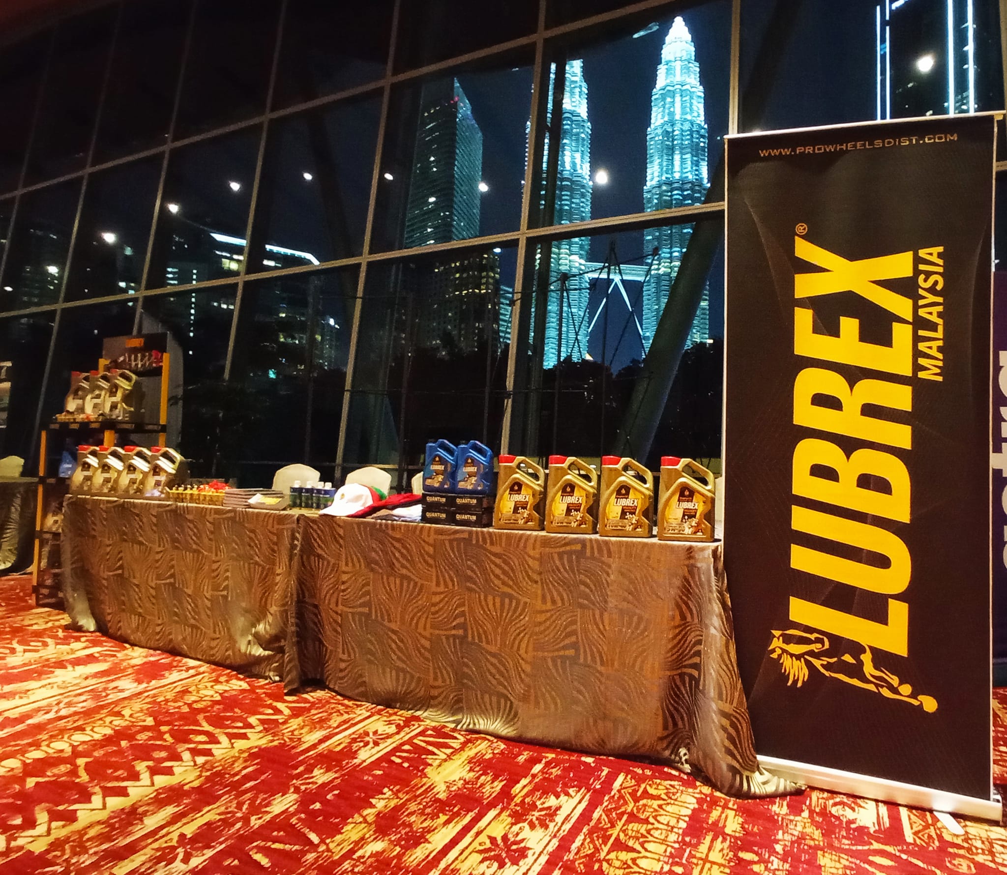 Modern lightweight plastic display rack showcasing lubricant products with custom branding