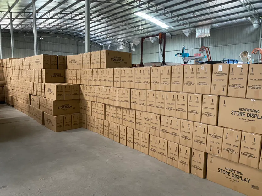 Organized warehouse facility with packaged display racks ready for shipment